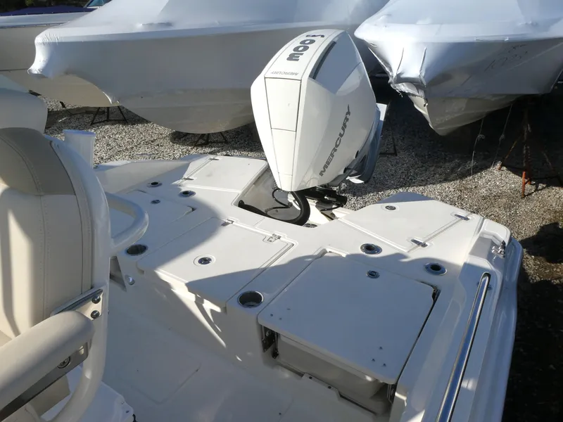 Slide: The Image of 2025 Boston Whaler 250 Dauntless boat with Mercury outboard engine, docked outdoors. - 10