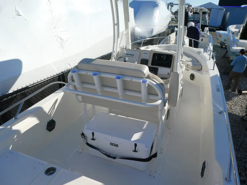 Slide: The Image of 2025 Boston Whaler 250 Dauntless boat interior with seating and console. - 2
