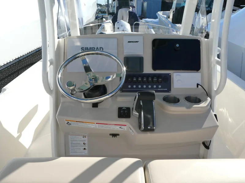 Slide: The Image of Boston Whaler 250 Dauntless 2025 helm with steering wheel and control panel. - 3