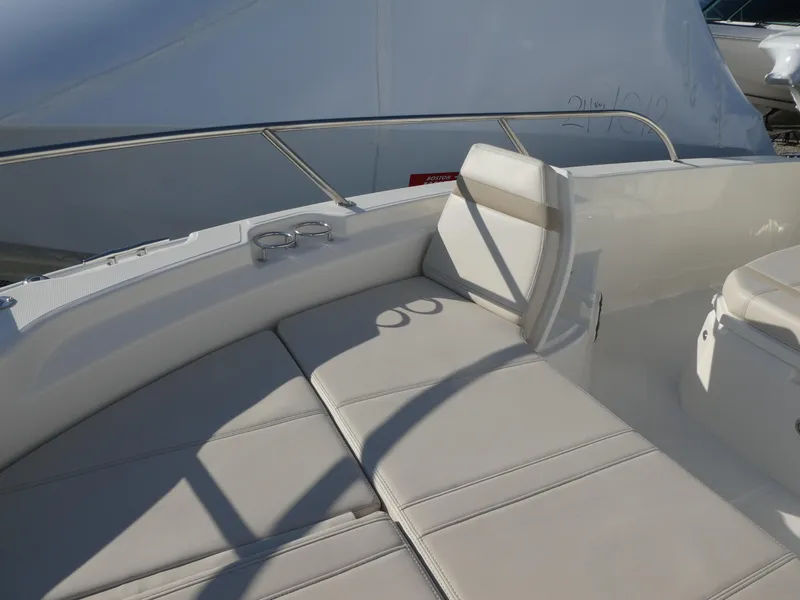 Slide: The Image of 2025 Boston Whaler 250 Dauntless boat interior with cushioned seating and cup holders. - 6