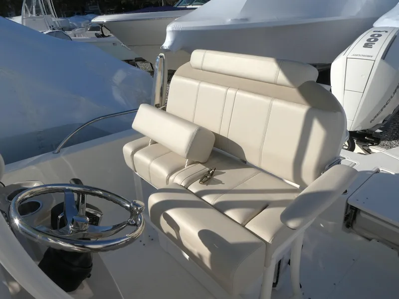 Slide: The Image of 2025 Boston Whaler 250 Dauntless boat interior with beige seating and steering wheel. - 9