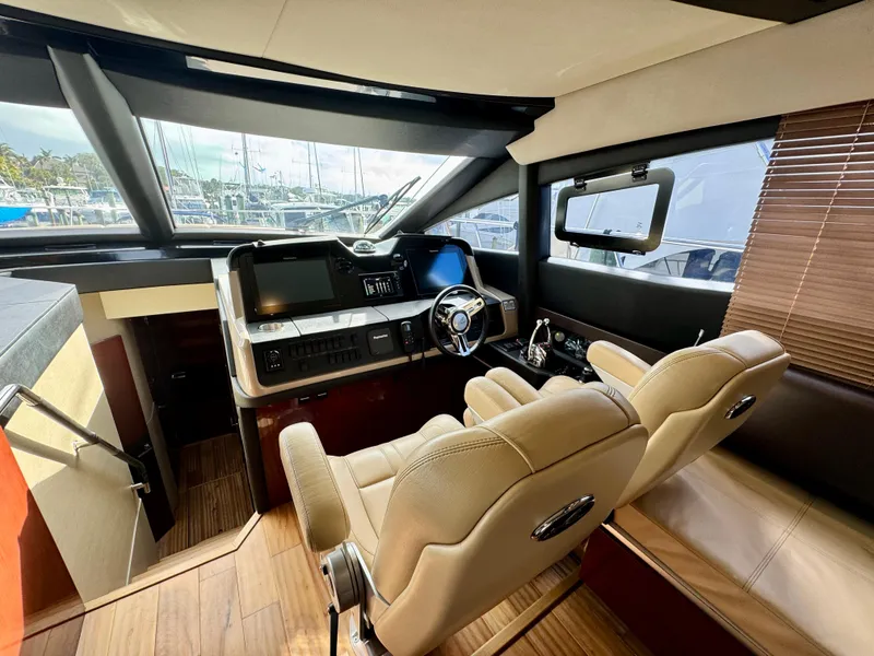 Slide: The Image of Luxurious 2017 Sea Ray L590 yacht helm with modern controls and plush seating. - 15