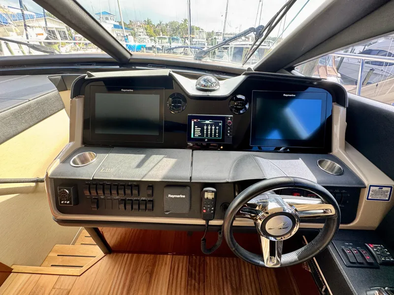 Slide: The Image of Helm of 2017 Sea Ray L590 yacht with dual screens and modern controls. - 18