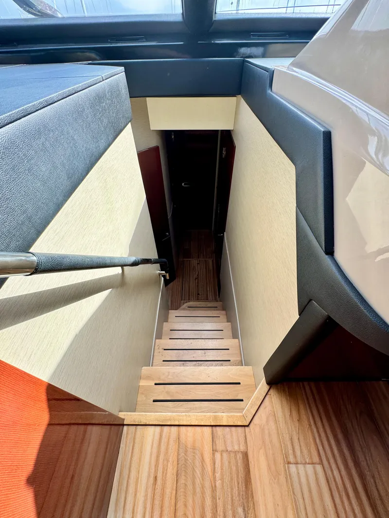 Slide: The Image of Staircase inside 2017 Sea Ray L590 yacht with wooden steps and modern design. - 19