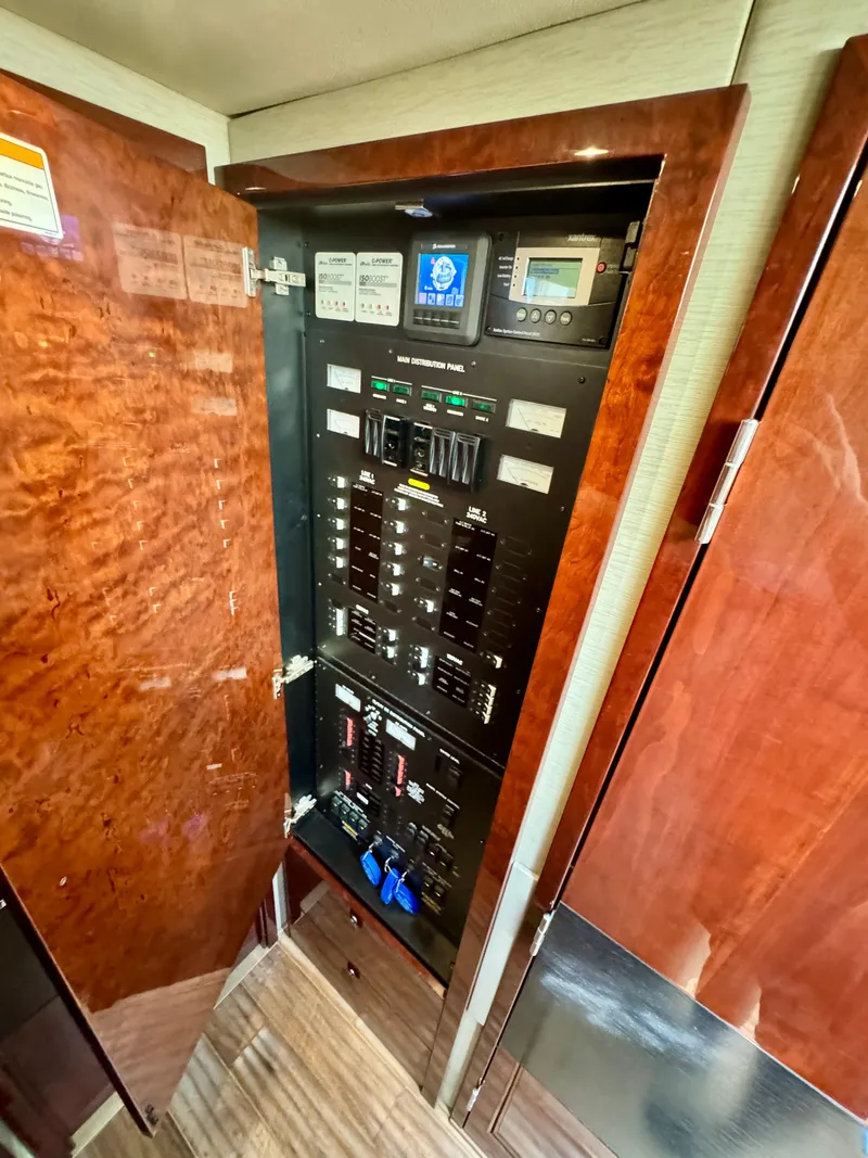 Slide: The Image of Electrical panel inside 2017 Sea Ray L590 yacht, featuring control switches and displays. - 23