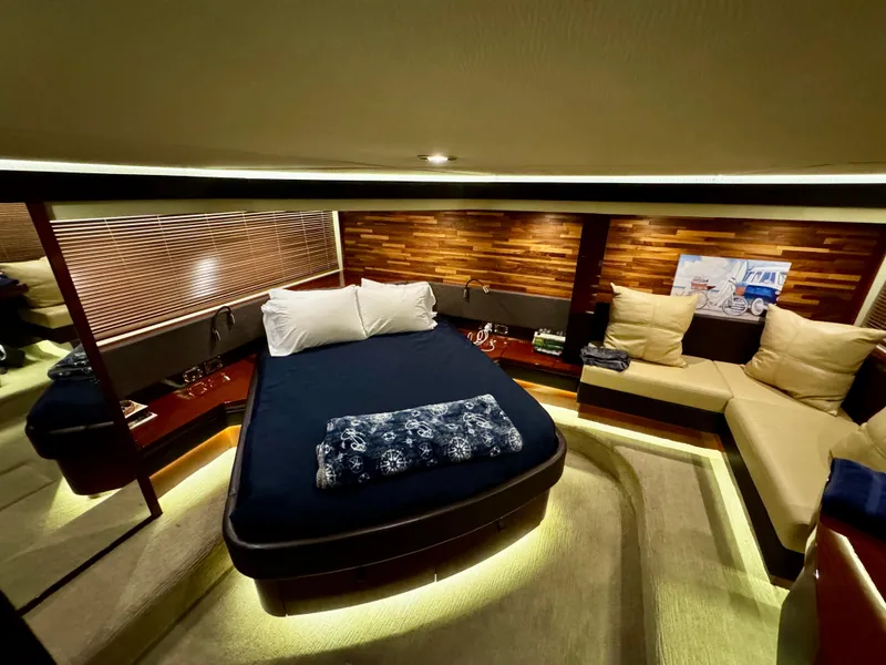 Slide: The Image of Luxurious 2017 Sea Ray L590 yacht cabin with elegant bedding and ambient lighting. - 29