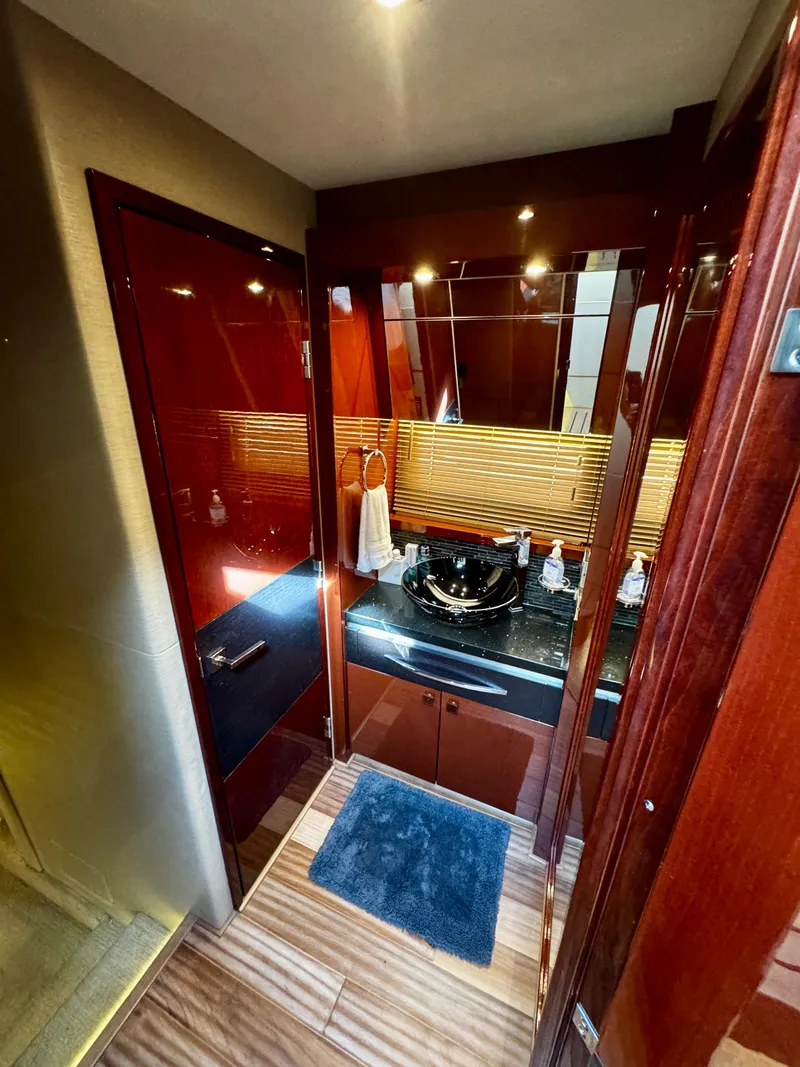 Slide: The Image of Luxurious bathroom interior of 2017 Sea Ray L590 yacht with modern fixtures and wood accents. - 34