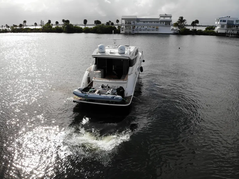 Slide: The Image of 2017 Sea Ray L590 yacht cruising on a calm waterway near waterfront homes. - 5