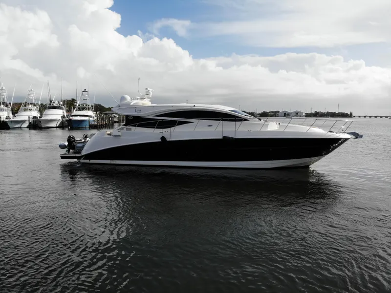 Slide: The Image of 2017 Sea Ray L590 yacht on calm water with cloudy sky background. - 7