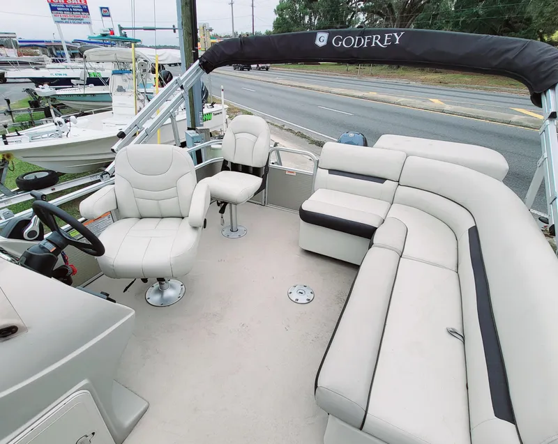 Slide: The Image of 2021 Godfrey SR 160 F pontoon boat with plush seating and modern design. - 7