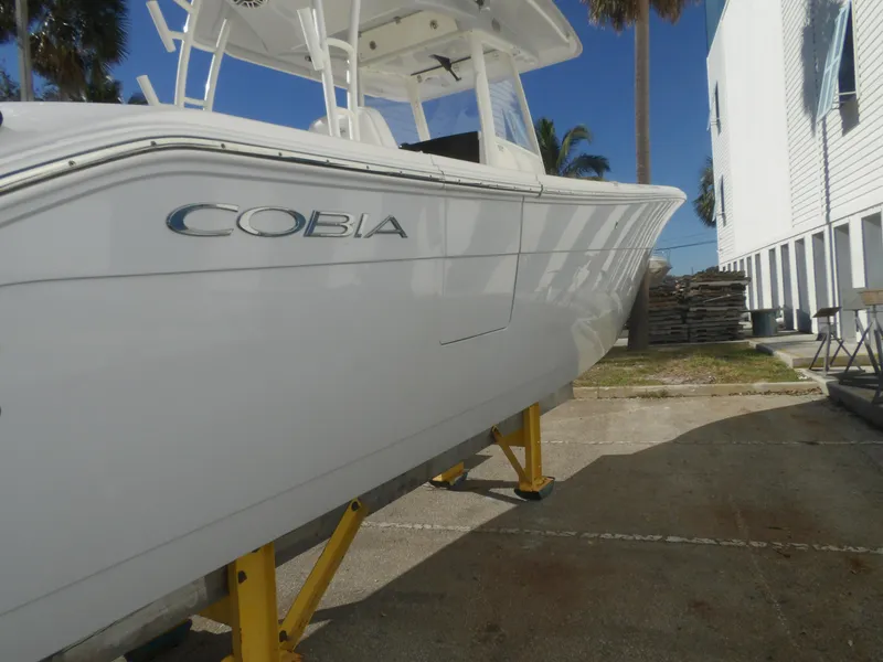Slide: The Image of 2020 Cobia 320 Center Console boat on stands, side view. - 17
