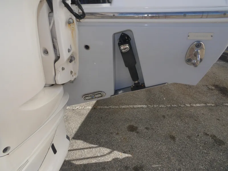 Slide: The Image of 2020 Cobia 320 Center Console boat detail showing engine mount and trim tab. - 19