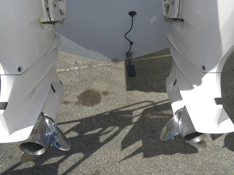 Slide: The Image of 2020 Cobia 320 Center Console boat with dual outboard engines and stainless steel propellers. - 20