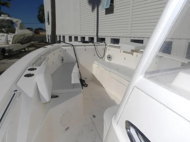 Slide: The Image of 2020 Cobia 320 Center Console boat interior with seating and cup holders. - 21