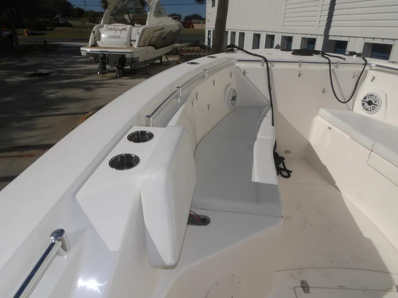 Slide: The Image of 2020 Cobia 320 Center Console boat interior with seating and cup holders. - 23