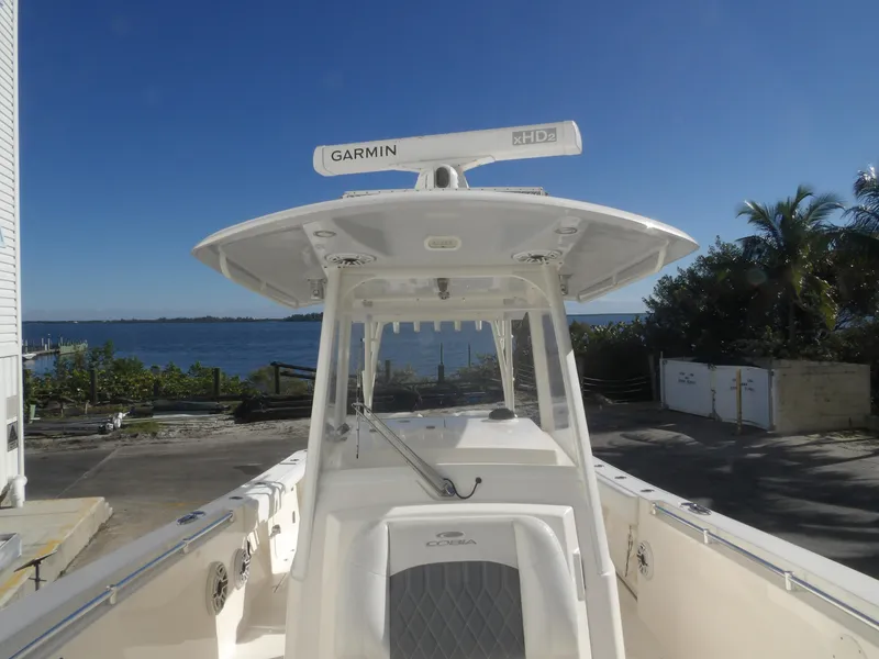 Slide: The Image of 2020 Cobia 320 Center Console boat docked near waterfront, featuring Garmin xHD2 radar. - 24