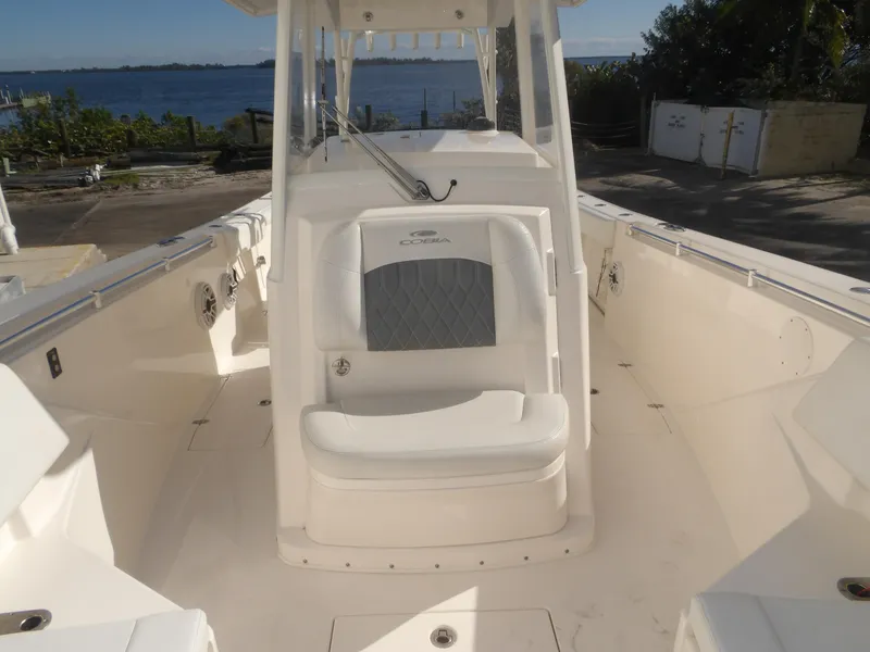 Slide: The Image of 2020 Cobia 320 Center Console boat interior with seating, near waterfront. - 25