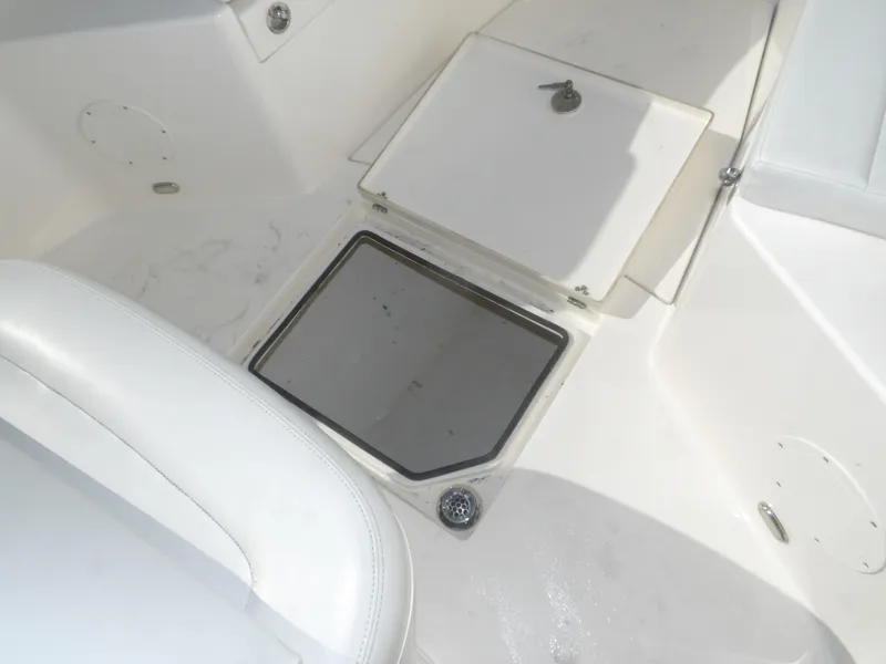 Slide: The Image of Cobia 320 Center Console 2020 boat deck with storage compartment and seating. - 29