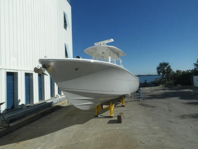 Slide: The Image of 2020 Cobia 320 Center Console boat on dry dock, clear sky background. - 3