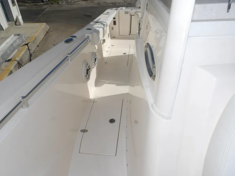 Slide: The Image of 2020 Cobia 320 Center Console boat interior, featuring spacious deck and storage compartments. - 31