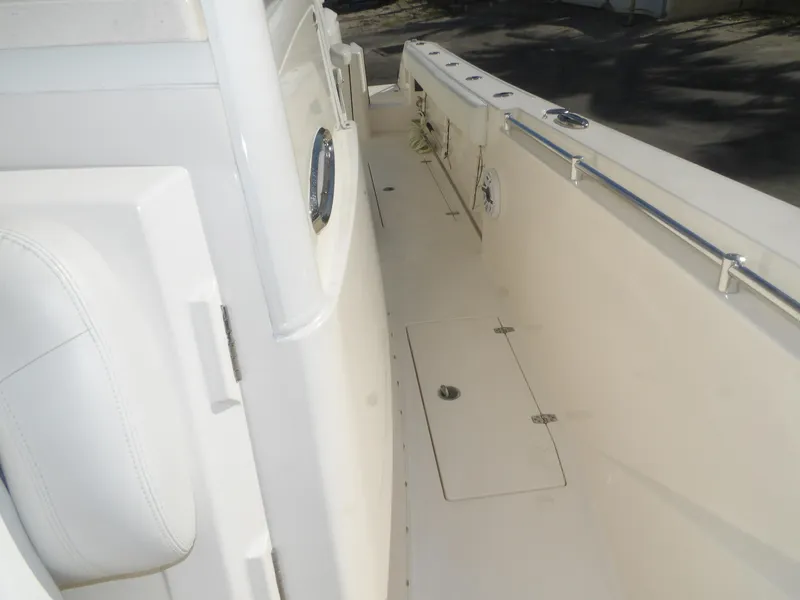 Slide: The Image of 2020 Cobia 320 Center Console boat deck with storage hatch and railing. - 32