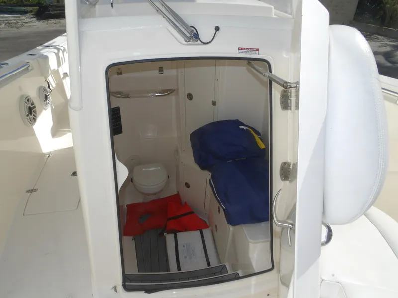 Slide: The Image of 2020 Cobia 320 Center Console boat interior with toilet and storage area. - 33