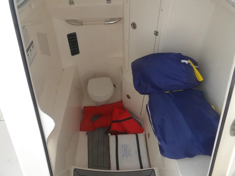 Slide: The Image of Interior of 2020 Cobia 320 Center Console boat with toilet and storage area. - 34