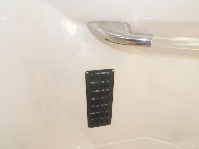 Slide: The Image of Control panel and handle on 2020 Cobia 320 Center Console boat interior. - 35