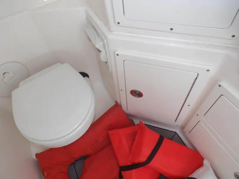 Slide: The Image of Interior of 2020 Cobia 320 Center Console with life jackets and marine toilet. - 40