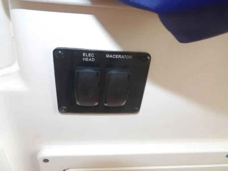 Slide: The Image of Switch panel on 2020 Cobia 320 Center Console boat, featuring electric head and macerator controls. - 42