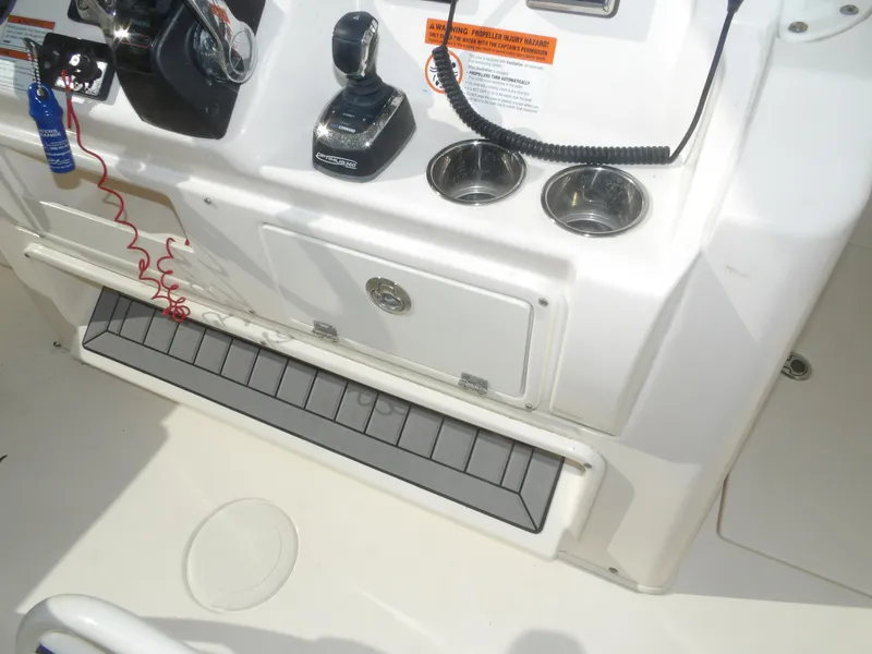 Slide: The Image of 2020 Cobia 320 Center Console boat dashboard with controls and cup holders. - 48