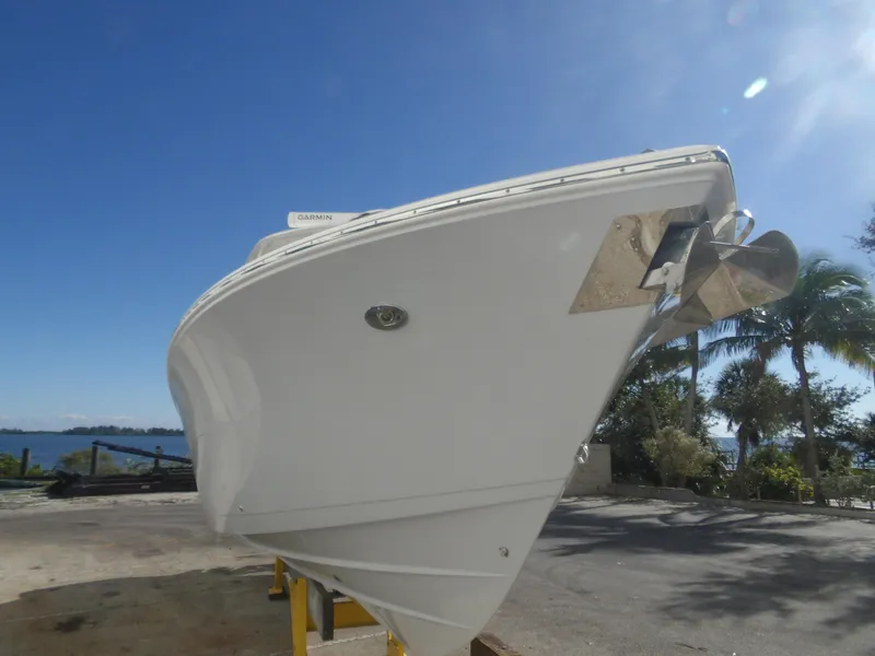 Slide: The Image of 2020 Cobia 320 Center Console boat on land, clear sky background. - 5