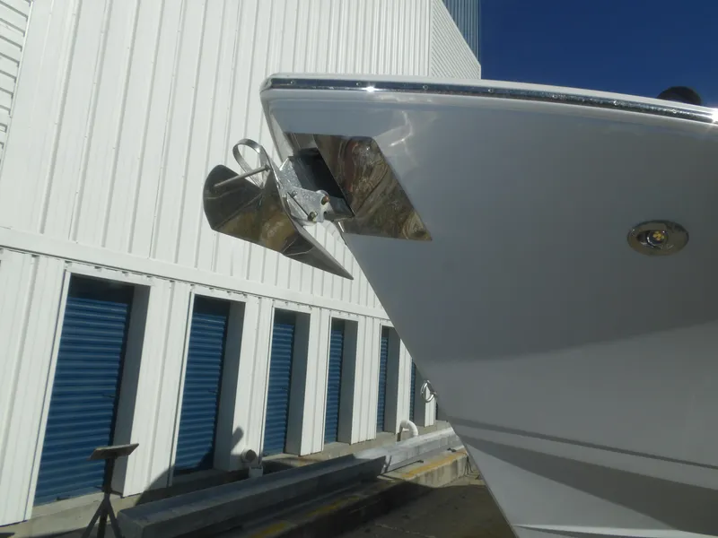 Slide: The Image of 2020 Cobia 320 Center Console boat anchor detail near storage facility. - 7