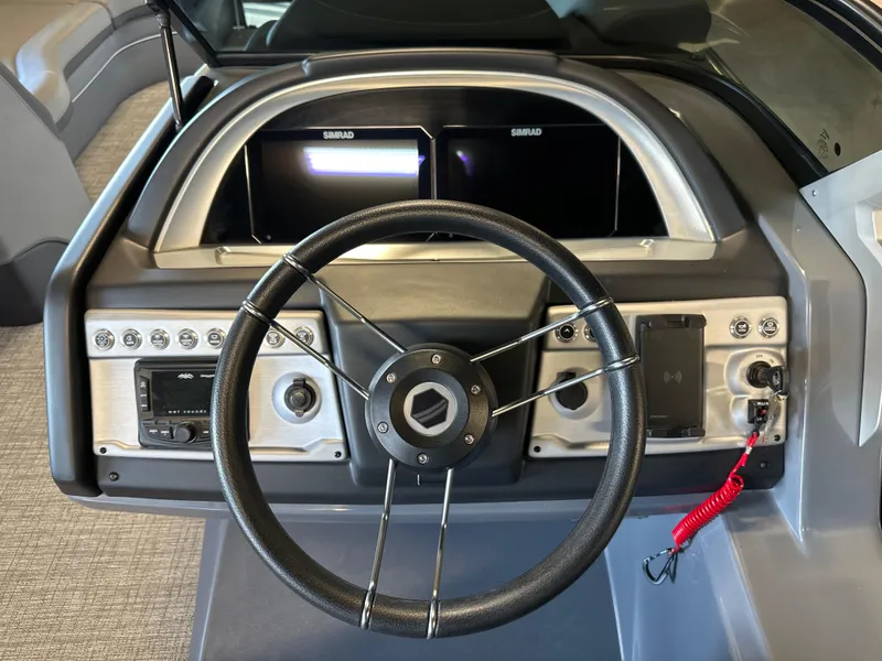 Slide: The Image of 2025 South Bay 525 RS boat dashboard with steering wheel and dual displays. - 7