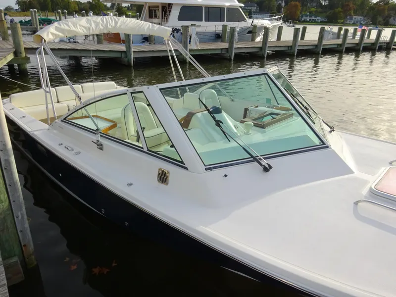 Slide: The Image of 2008 Hunt Yachts Harrier 25 docked, featuring sleek design and spacious seating. - 10