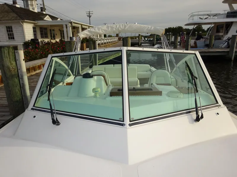 Slide: The Image of 2008 Hunt Yachts Harrier 25 docked, featuring a sleek windshield and spacious seating. - 11