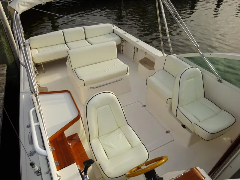 Slide: The Image of 2008 Hunt Yachts Harrier 25 interior with white seating and wooden accents. - 14