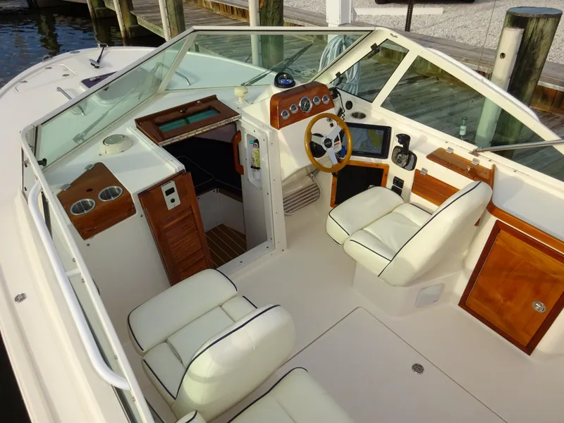 Slide: The Image of 2008 Hunt Yachts Harrier 25 interior with white seating, wooden accents, and modern dashboard. - 18