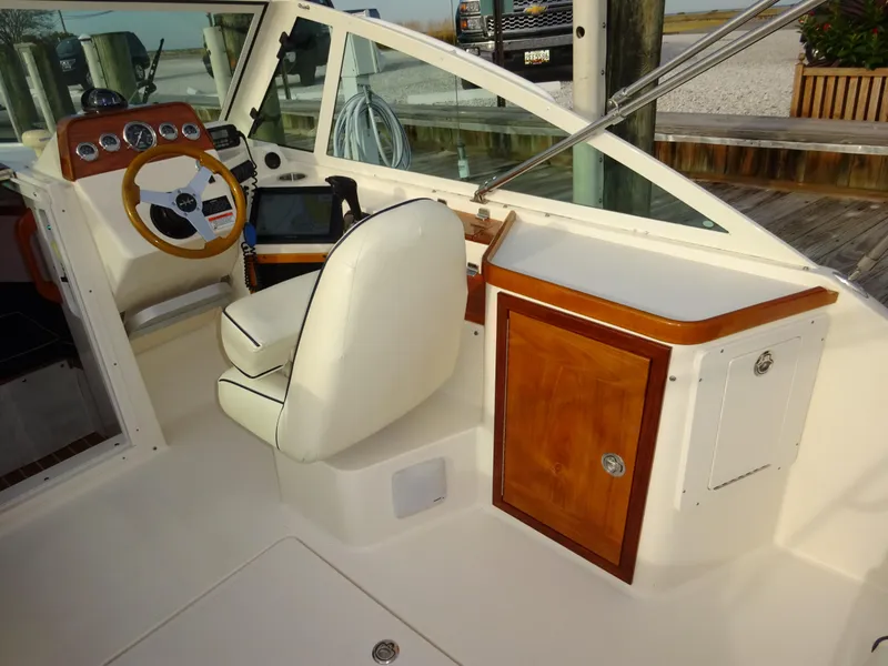 Slide: The Image of 2008 Hunt Yachts Harrier 25 cockpit with steering wheel, dashboard, and seating. - 20