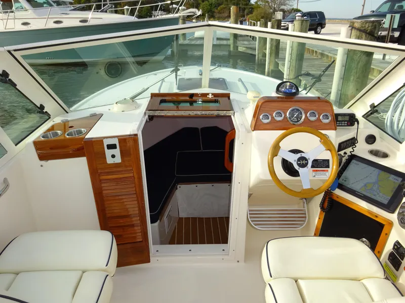 Slide: The Image of 2008 Hunt Yachts Harrier 25 cockpit with steering wheel, navigation instruments, and seating. - 23