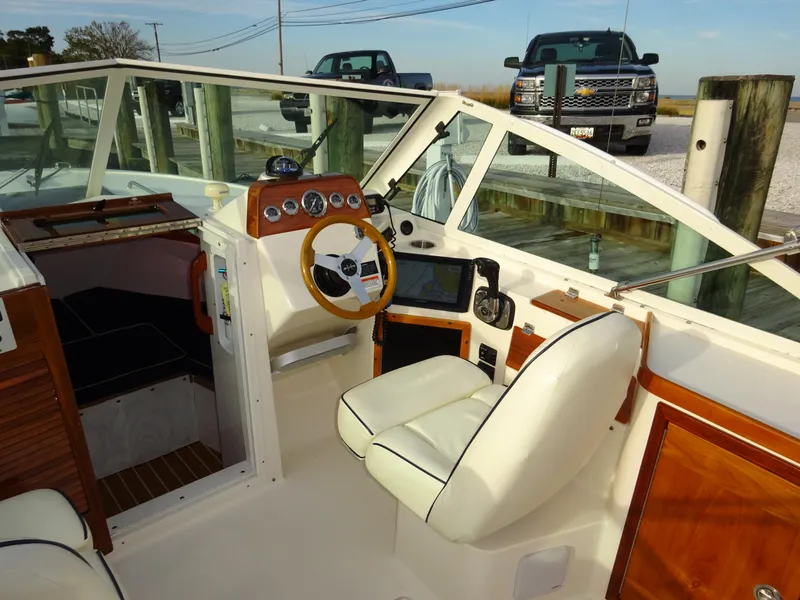 Slide: The Image of 2008 Hunt Yachts Harrier 25 interior with steering wheel, dashboard, and seating. - 24