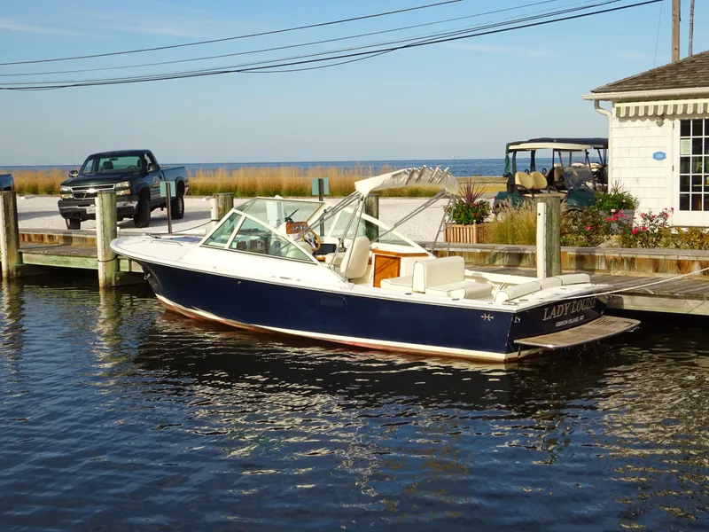 Slide: The Image of 2008 Hunt Yachts Harrier 25 docked by a waterfront building. - 4