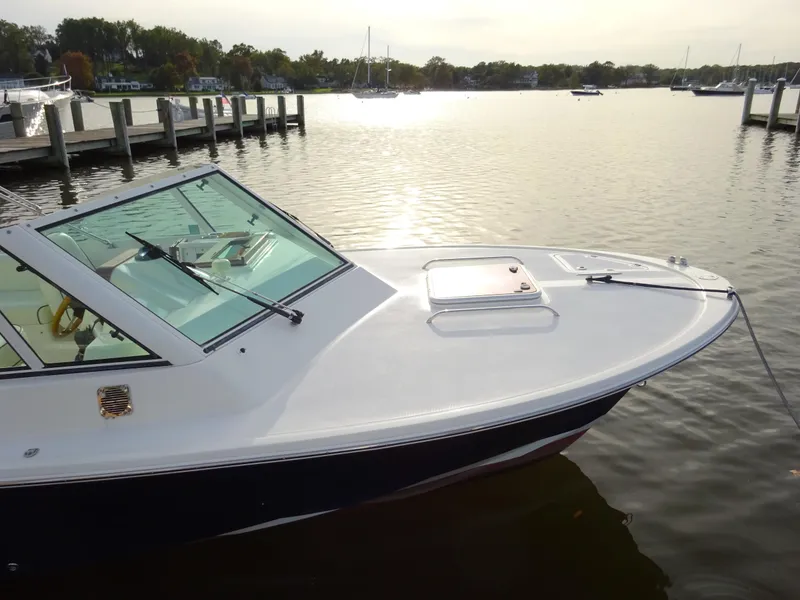 Slide: The Image of 2008 Hunt Yachts Harrier 25 docked on calm water at sunset. - 8