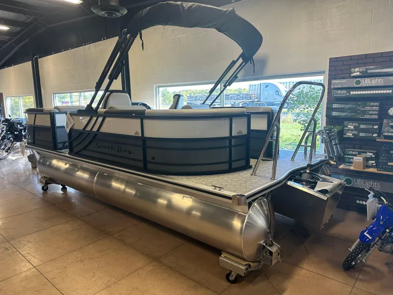 Slide: The Image of 2025 South Bay 222 RS LE pontoon boat displayed indoors. - 4