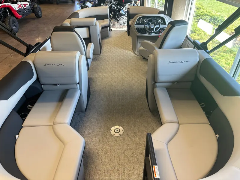 Slide: The Image of 2025 South Bay 222 RS LE pontoon boat interior with plush seating and modern dashboard. - 5