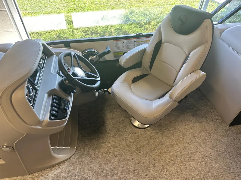 Slide: The Image of 2025 South Bay 222 RS LE boat interior with captain's chair and steering console. - 7