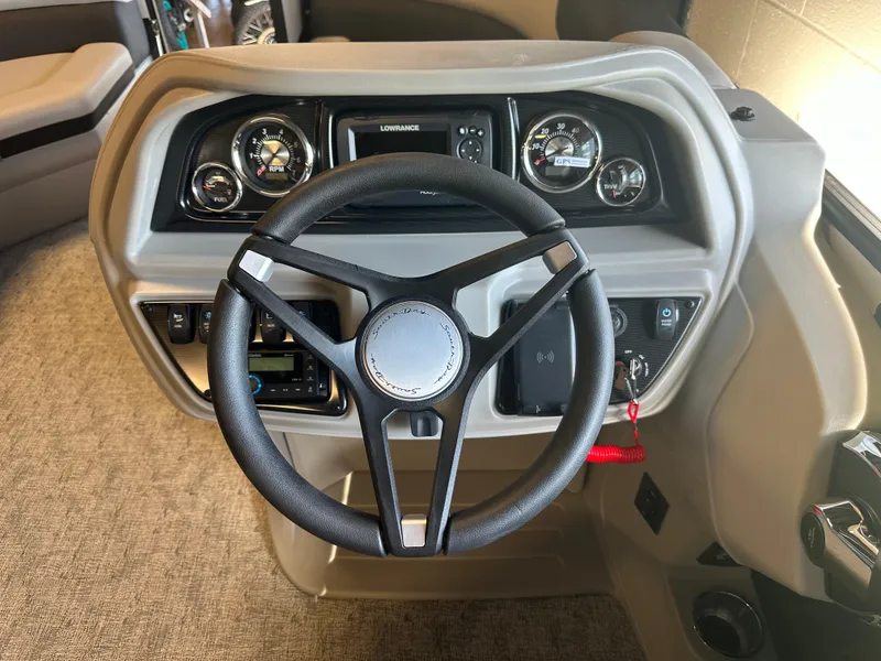 Slide: The Image of 2025 South Bay 222 RS LE boat dashboard with steering wheel and gauges. - 8