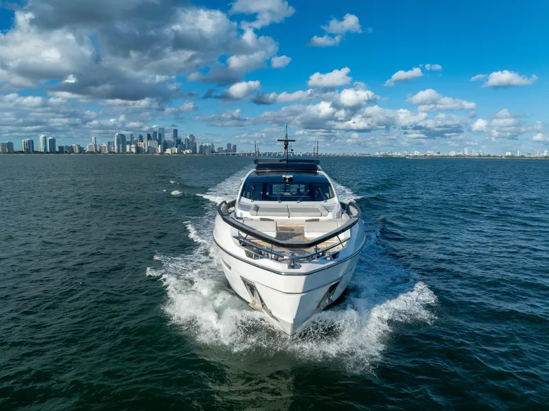 Slide: The Image of Azimut S10 2021 luxury yacht cruising on open water with city skyline backdrop. - 11