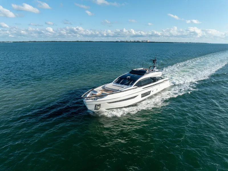 Slide: The Image of Azimut S10 2021 yacht cruising on open water under a clear blue sky. - 14