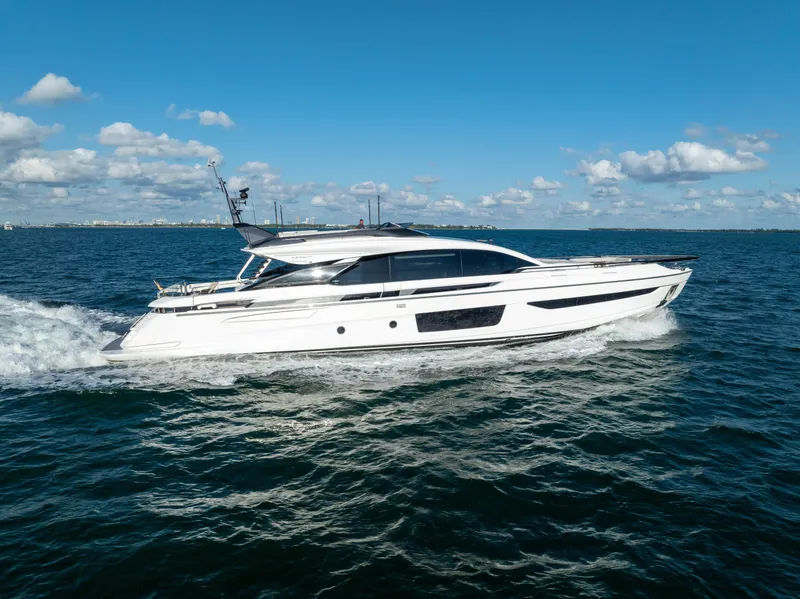 Slide: The Image of 2021 Azimut S10 yacht cruising on open water under a clear blue sky. - 2